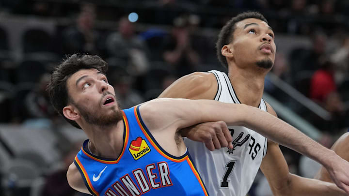 Feb 29, 2024; San Antonio, Texas, USA;  Oklahoma City Thunder forward Chet Holmgren (7) and San Antonio Spurs center Victor Wembanyama (1) battle for position in the first half at Frost Bank Center. Mandatory Credit: Daniel Dunn-Imagn Images