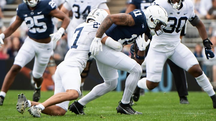 Penn State safety Lamont Payne Jr. (27) tackles wide receiver Kyron Hudson (11) during the Blue-White game at Beaver Stadium