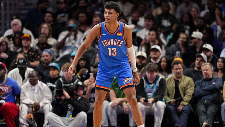 Nov 15, 2025; Charlotte, North Carolina, USA; Oklahoma City Thunder forward Ousmane Dieng (13) on defense against the Charlotte Hornets during the second half at Spectrum Center. Mandatory Credit: Jim Dedmon-Imagn Images