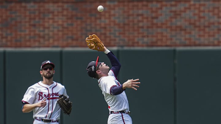 May 15, 2025; Cumberland, Georgia, USA; Atlanta Braves shortstop Nick Allen (2) catches a fly ball between outfielder outfielder Eli White (36) and second base Ozzie Albies (1) against the Washington Nationals during the second inning at Truist Park. Mandatory Credit: Dale Zanine-Imagn Images