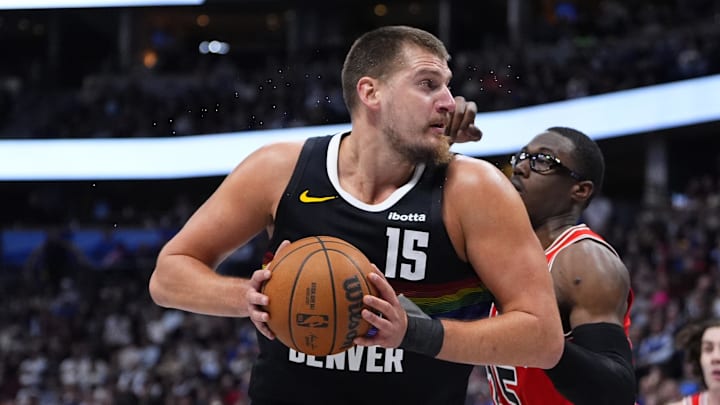 Nov 17, 2025; Denver, Colorado, USA;  Chicago Bulls forward/center Jalen Smith (25) defends on Denver Nuggets center Nikola Jokic (15) in the second half at Ball Arena.