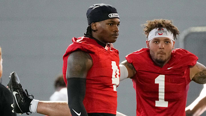 Ohio State Buckeyes wide receivers Brandon Inniss (1) and Jeremiah Smith (4) warm up during spring football practice at the Woody Hayes Athletic Center on March 17, 2025.