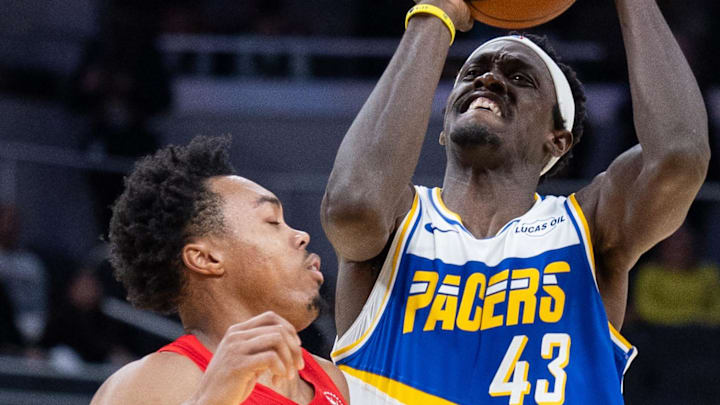 Indiana Pacers forward Pascal Siakam shoots the ball while Toronto Raptors forward Scottie Barnes defends.