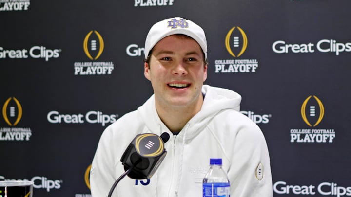 Jan 18, 2025; Atlanta, GA, USA; Notre Dame Fighting Irish quarterback Riley Leonard (13) talks to the media during 2025 CFP National Championship Media Day at Georgia World Congress Center, Building A.