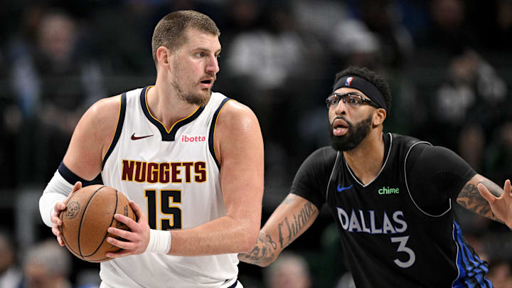 Dec 23, 2025; Dallas, Texas, USA; Denver Nuggets center Nikola Jokic (15) looks to move the ball past Dallas Mavericks forward Anthony Davis (3) during the game between the Mavericks and the Nuggets at the American Airlines Center. Mandatory Credit: Jerome Miron-Imagn Images