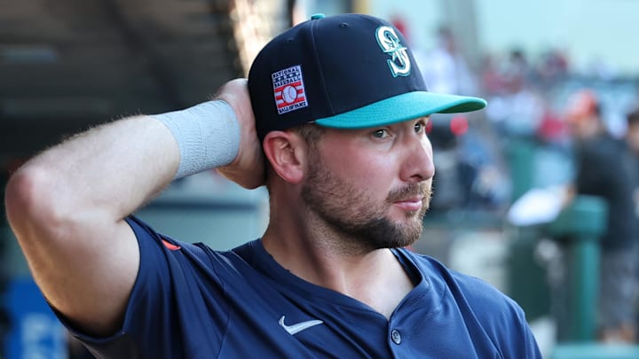 Seattle Mariners catcher Cal Raleigh walks in the dugout during a game against the Los Angeles Angels on July 25 at Angel Stadium. Seattle Mariners catcher Cal Raleigh walks in the dugout during a game against the Los Angeles Angels on July 25 at Angel Stadium.