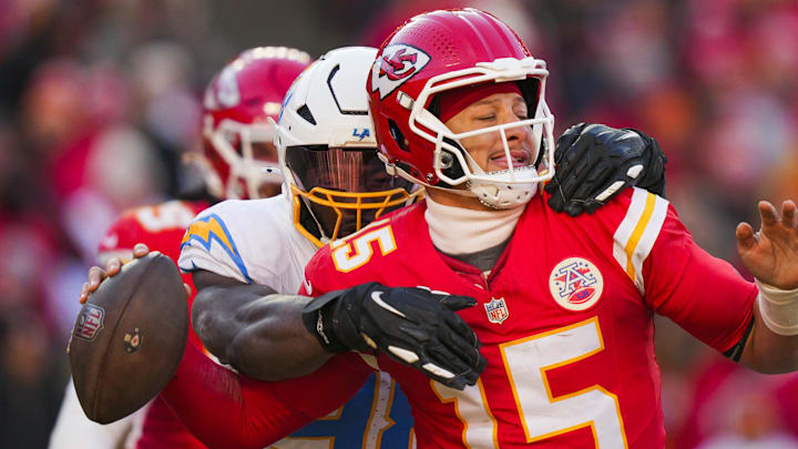 Dec 14, 2025; Kansas City, Missouri, USA; Los Angeles Chargers linebacker Odafe Oweh (98) sacks Kansas City Chiefs quarterback Patrick Mahomes (15) during the second half at GEHA Field at Arrowhead Stadium. Mandatory Credit: Jay Biggerstaff-Imagn Images