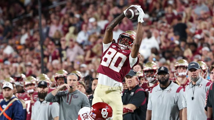 Dec 29, 2022; Orlando, Florida, USA;Florida State Seminoles wide receiver Ontaria Wilson (80) catches a pass and tackled by Oklahoma Sooners defensive back C.J. Coldon (22) during the 2022 Cheez-It Bowl at Camping World Stadium. Mandatory Credit: Nathan Ray Seebeck-Imagn Images