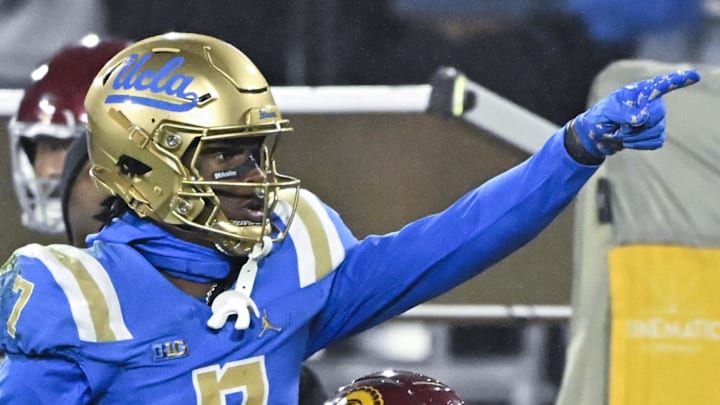 Nov 23, 2024; Pasadena, California, USA; UCLA Bruins wide receiver J.Michael Sturdivant (7) signals a first down after catching a long pass over USC Trojans cornerback Jacobe Covington (14) in the third quarter at Rose Bowl. Mandatory Credit: Robert Hanashiro-Imagn Images