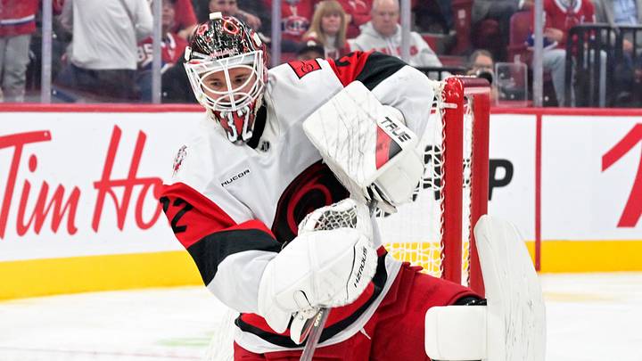 Oct 6, 2026; Montreal, Quebec, CAN; Carolina Hurricanes goalie Brandon Bussi (32) clears the puck during the third period of the game against the Montreal Canadiens at the Bell Centre.  Mandatory Credit: Eric Bolte-Imagn Images