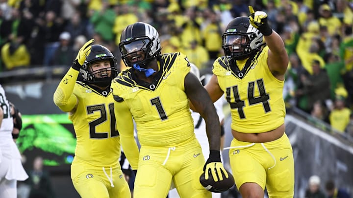 Oct 4, 2024; Eugene, Oregon, USA; Oregon Ducks defensive end Jordan Burch (1) celebrates with teammates linebacker Bryce Boettcher (28) and linebacker Teitum Tuioti (44) after recovering a fumble for a safety during the first half against the Michigan State Spartans at Autzen Stadium. Mandatory Credit: Troy Wayrynen-Imagn Images