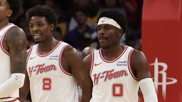 Nov 8, 2023; Houston, Texas, USA; Houston Rockets guard Jalen Green (4) reacts to his basket while forward Jae'Sean Tate (8) and guard Aaron Holiday (0) look on against the Los Angeles Lakers in the second half at Toyota Center. Mandatory Credit: Thomas Shea-Imagn Images