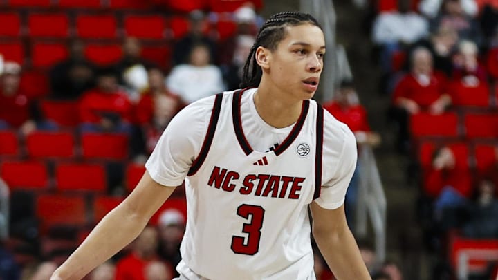 Dec 6, 2025; Raleigh, North Carolina, USA; NC State Wolfpack guard Matt Able (3) dribbles the ball against UNC Asheville Bulldogs guard Corey Jones (24) during the first half of the game at Lenovo Center. Mandatory Credit: Jaylynn Nash-Imagn Images