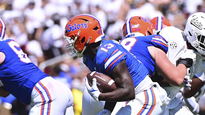 Sep 21, 2024; Starkville, Mississippi, USA; Florida Gators running back Jadan Baugh (13) runs the ball against the Mississippi State Bulldogs during the fourth quarter at Davis Wade Stadium at Scott Field. Mandatory Credit: Matt Bush-Imagn Images