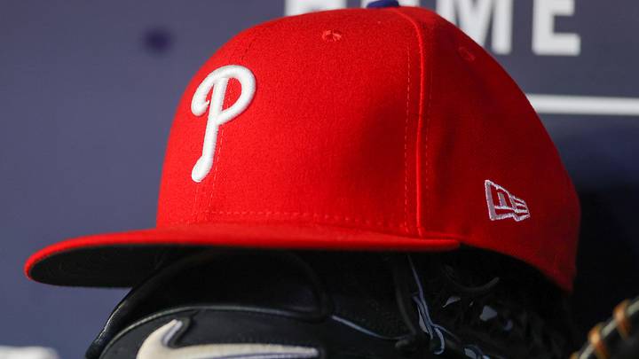 May 26, 2023; Atlanta, Georgia, USA; A detailed view of a Philadelphia Phillies hat and glove on the bench against the Atlanta Braves in the seventh inning at Truist Park.