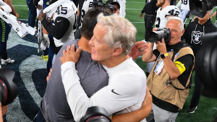 Aug 7, 2025; Seattle, Washington, USA; Las Vegas Raiders head coach Pete Carroll and Seattle Seahawks head coach Mike Macdonald hug after the game at Lumen Field. Mandatory Credit: Steven Bisig-Imagn Images