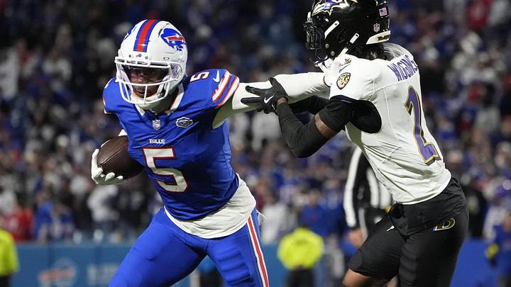 Buffalo Bills wide receiver Joshua Palmer runs the ball against Baltimore Ravens cornerback Nate Wiggins.