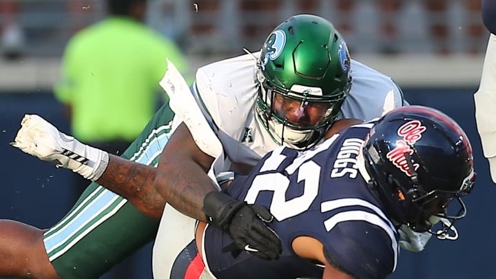 Sep 20, 2025; Oxford, Mississippi, USA; Tulane Green Wave defensive linemen Eliyt Nairne (90) tackles Mississippi Rebels running back Logan Diggs (22) during the fourth quarter at Vaught-Hemingway Stadium. Mandatory Credit: Petre Thomas-Imagn Images