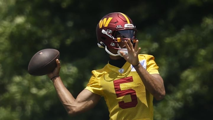 Washington Commanders quarterback Jayden Daniels passes the ball on day one of minicamp at Commanders Park.