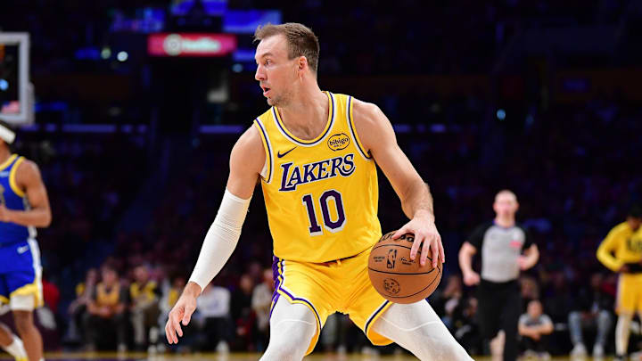 Feb 7, 2026; Los Angeles, California, USA; Los Angeles Lakers guard Luke Kennard (10) controls the ball against the Golden State Warriors during the first half at Crypto.com Arena. Mandatory Credit: Gary A. Vasquez-Imagn Images