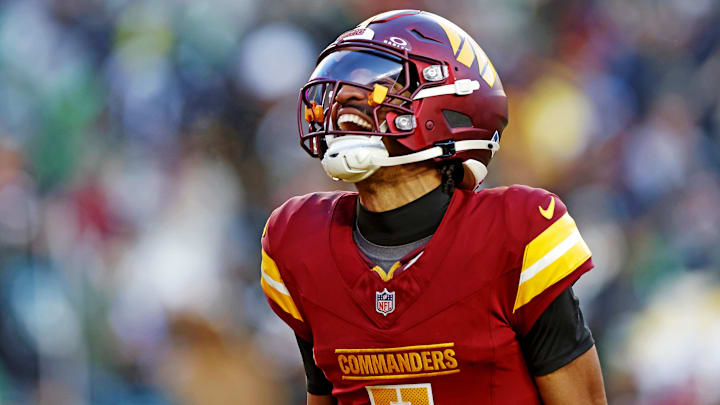 Dec 22, 2024; Landover, Maryland, USA; Washington Commanders quarterback Jayden Daniels (5) celebrates after throwing a touchdown during the fourth quarter against the Philadelphia Eagles at Northwest Stadium. Mandatory Credit: Peter Casey-Imagn Images