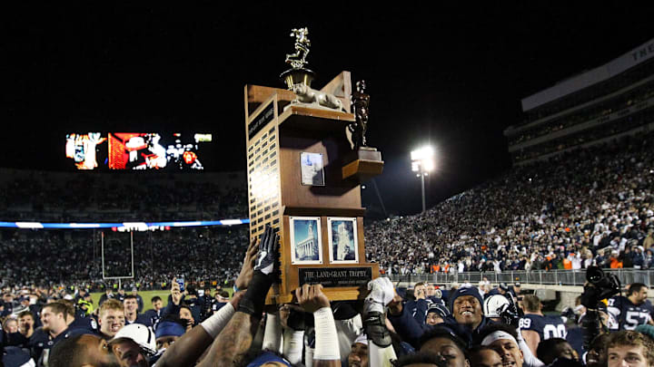 Nov 26, 2016; University Park, PA, USA; Penn State Nittany Lions football players carry the Land-Grant trophy following the competition of the game at Beaver Stadium. Penn State defeated Michigan State 45-12. Mandatory Credit: Matthew O'Haren-Imagn Images
