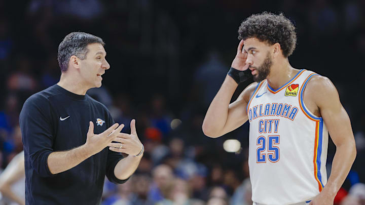 Oct 9, 2024; Oklahoma City, Oklahoma, USA; Oklahoma City Thunder head coach Mark Daigneault talks to guard Ajay Mitchell (25) during a break in play in the second half at Paycom Center. Mandatory Credit: Alonzo Adams-Imagn Images