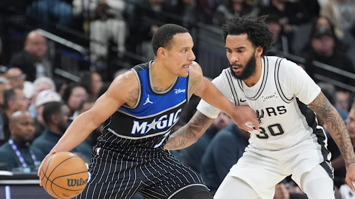 Feb 1, 2026; San Antonio, Texas, USA;  Orlando Magic guard Desmond Bane (3) dribbles against San Antonio Spurs forward Julian Champagnie (30) in the first half at Frost Bank Center. Mandatory Credit: Daniel Dunn-Imagn Images