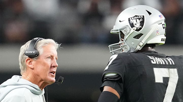 Nov 23, 2025; Paradise, Nevada, USA; Las Vegas Raiders quarterback Geno Smith (7) talks to head coach Pete Carroll in game against the Cleveland Browns during the fourth quarter at Allegiant Stadium. Mandatory Credit: Stephen R. Sylvanie-Imagn Images Nov 23, 2025; Paradise, Nevada, USA; Las Vegas Raiders quarterback Geno Smith (7) talks to head coach Pete Carroll in game against the Cleveland Browns during the fourth quarter at Allegiant Stadium. Mandatory Credit: Stephen R. Sylvanie-Imagn Images