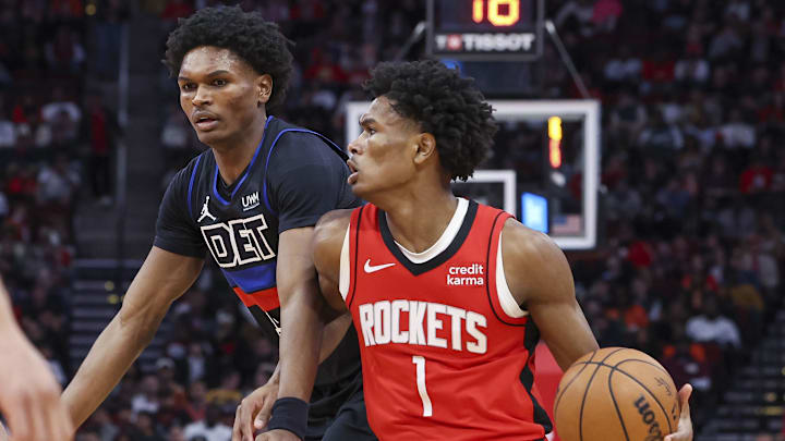 Jan 1, 2024; Houston, Texas, USA; Houston Rockets forward Amen Thompson (1) controls the ball as Detroit Pistons forward Ausar Thompson (9) defends during the fourth quarter at Toyota Center. Mandatory Credit: Troy Taormina-Imagn Images