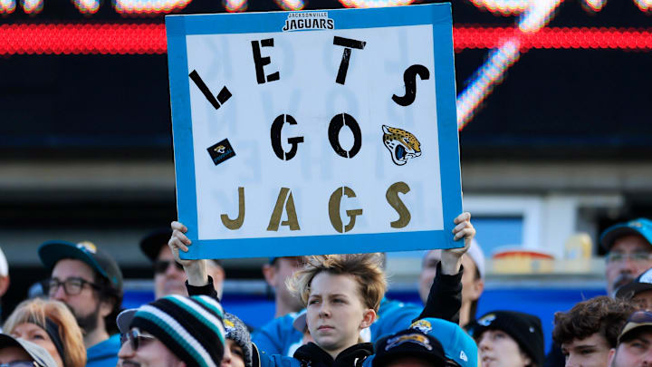 A Jacksonville Jaguars fan holds up a sign during the second quarter of an NFL football matchup at EverBank Stadium, Sunday, Jan. 4, 2026, in Jacksonville, Fla. The Jaguars defeated the Titans 41-7, capturing the AFC South title. [Corey Perrine/Florida Times-Union]
