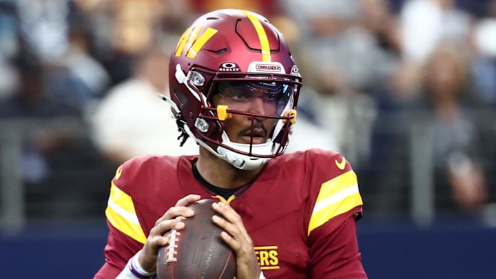 Oct 19, 2025; Arlington, Texas, USA; Washington Commanders quarterback Jayden Daniels (5) looks to pass the ball against the Dallas Cowboys during the first quarter of the game at AT&T Stadium. Mandatory Credit: Kevin Jairaj-Imagn Images