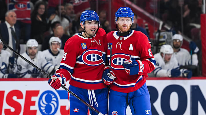 Sep 25, 2025; Montreal, Quebec, CAN; Montreal Canadiens defenseman Mike Matheson (8) celebrates his goal with center Nick Suzuki (14) against the Toronto Maple Leafs during the first period at Bell Centre. Mandatory Credit: David Kirouac-Imagn Images