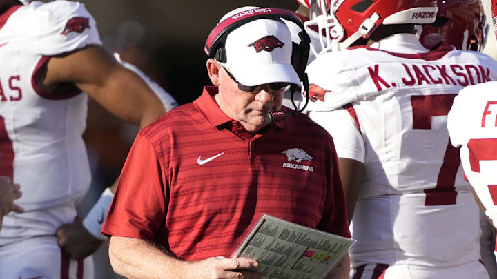 Arkansas Razorbacks interim coach Bobby Petrino looks at his notes during the first half against the Texas Longhorns at Darrell K Royal-Texas Memorial Stadium. 