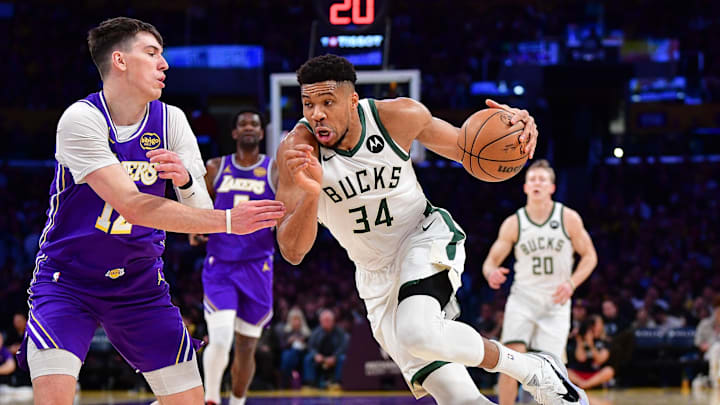 Jan 9, 2026; Los Angeles, California, USA; Milwaukee Bucks forward Giannis Antetokounmpo (34) moves the ball against Los Angeles Lakers forward Jake LaRavia (12) during the first half at Crypto.com Arena. Mandatory Credit: Gary A. Vasquez-Imagn Images