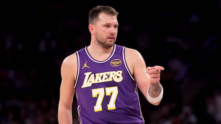 Feb 1, 2026; New York, New York, USA; Los Angeles Lakers guard Luka Doncic (77) points in the direction of Knicks fan Spike Lee (not pictured) after a three point shot against the New York Knicks during the third quarter at Madison Square Garden. Mandatory Credit: Brad Penner-Imagn Images