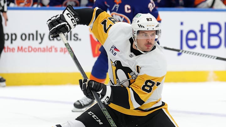 Nov 5, 2024; Elmont, New York, USA; Pittsburgh Penguins center Sidney Crosby (87) passes the puck backwards between his legs during the first period against the New York Islanders at UBS Arena. Mandatory Credit: Brad Penner-Imagn Images