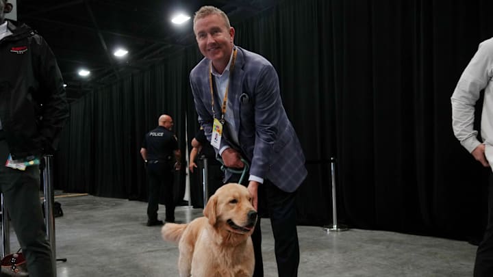 Jan 17, 2026; Miami Gardens, FL, USA; ESPN analyst Kirk Herbstreit with his dog Peter during media day for the 2025 College Football Playoff National Championship at Miami Beach Convention Center. Mandatory Credit: Kirby Lee-Imagn Images