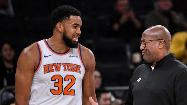 Oct 9, 2025; New York, New York, USA; New York Knicks head coach Mike Brown reacts as he talks with center/forward Karl-Anthony Towns (32) during the first half against the Minnesota Timberwolves at Madison Square Garden. Mandatory Credit: John Jones-Imagn Images