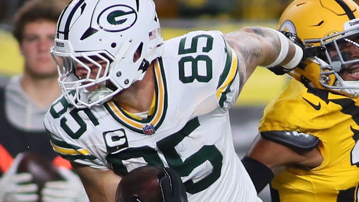 Green Bay Packers tight end Tucker Kraft (85) fights past Pittsburgh Steelers defensive back Chuck Clark for a touchdown.