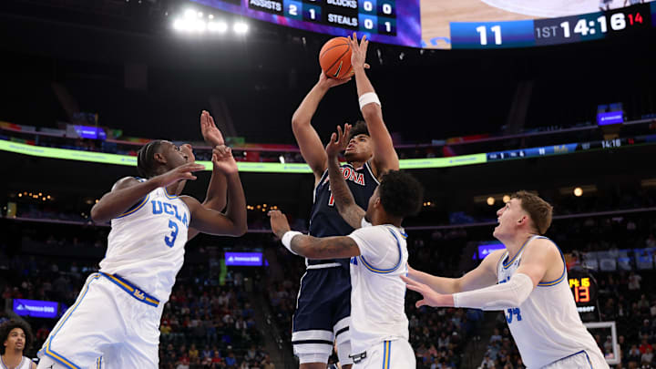 Nov 14, 2025; Inglewood, California, USA;  Arizona Wildcats forward Koa Peat (10) shoots the ball over UCLA Bruins forward Eric Dailey Jr. (3) during the first half of the Hall of Fame Series game at Intuit Dome. Mandatory Credit: Kiyoshi Mio-Imagn Images