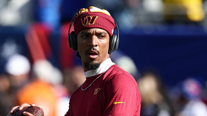 Nov 3, 2024; East Rutherford, New Jersey, USA; Washington Commanders quarterback Jayden Daniels (5) warms up before the game against the New York Giants at MetLife Stadium. Mandatory Credit: Vincent Carchietta-Imagn Images