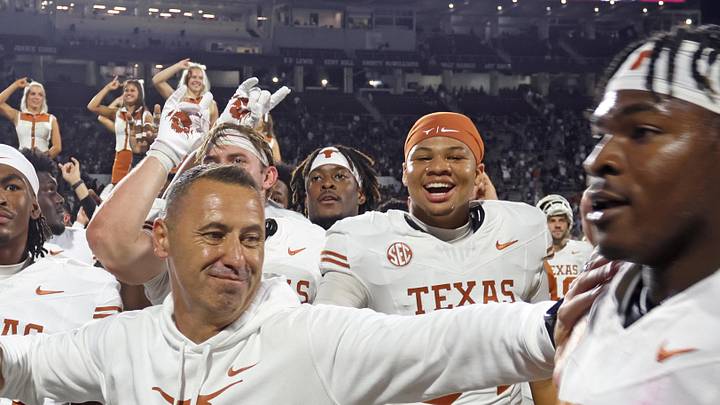 Texas Longhorns head coach Steve Sarkisian reacts with defensive linemen Colin Simmons (1) after beating the Mississippi State Bulldogs in overtime at Davis Wade Stadium at Scott Field.
