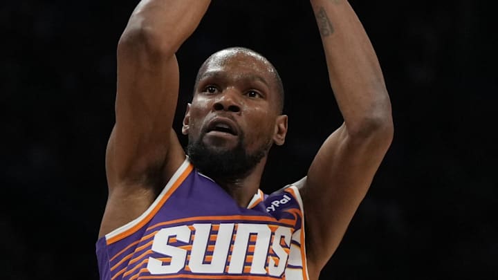 Mar 26, 2025; Phoenix, Arizona, USA; Phoenix Suns forward Kevin Durant (35) shoots against the Boston Celtics during the first half at Footprint Center. Mandatory Credit: Rick Scuteri-Imagn Images