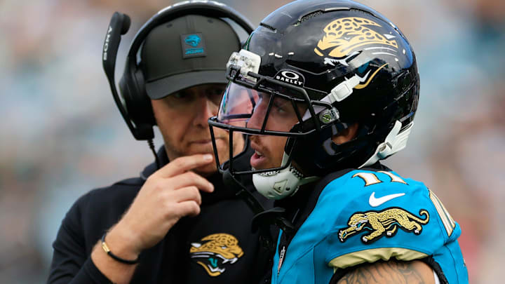 Jacksonville Jaguars wide receiver Parker Washington (11) walks off the field after a hit as head coach Liam Coen looks on during the second quarter of an NFL football matchup at EverBank Stadium, Sunday, Jan. 4, 2026, in Jacksonville, Fla. The Jaguars defeated the Titans 41-7, capturing the AFC South title. [Corey Perrine/Florida Times-Union]
