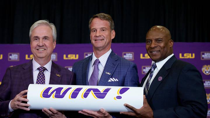 LSU president Wade Rousse, left, LSU new head coach Lane Kiffin and LSU athletic director Verge Ausberry stand together at South Stadium Club at Tiger Stadium. 