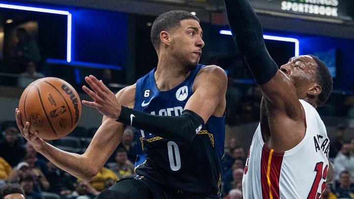 Dec 12, 2022; Indianapolis, Indiana, USA; Indiana Pacers guard Tyrese Haliburton (0) passes the ball while Miami Heat center Bam Adebayo (13) defends in the first quarter at Gainbridge Fieldhouse. Mandatory Credit: Trevor Ruszkowski-USA TODAY Sports Dec 12, 2022; Indianapolis, Indiana, USA; Indiana Pacers guard Tyrese Haliburton (0) passes the ball while Miami Heat center Bam Adebayo (13) defends in the first quarter at Gainbridge Fieldhouse. Mandatory Credit: Trevor Ruszkowski-USA TODAY Sports