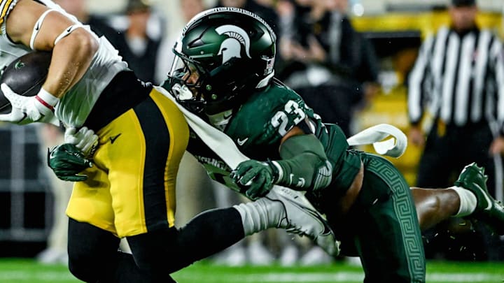 Michigan State's Darius Snow, right, tackles Iowa's Kaden Wetjen in the first quarter on Saturday, Oct. 19, 2024, at Spartan Stadium in East Lansing.