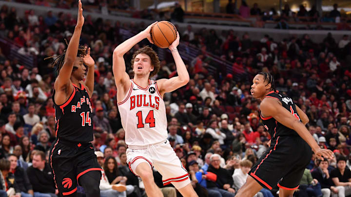 Feb 28, 2025; Chicago, Illinois, USA; Chicago Bulls forward Matas Buzelis (14) drives against Toronto Raptors guard Ja'Kobe Walter (14) during the second half at the United Center. Mandatory Credit: Patrick Gorski-Imagn Images