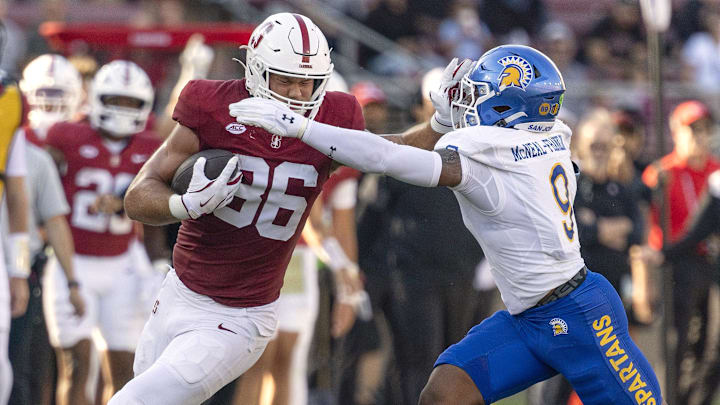 Sep 27, 2025; Stanford, California, USA;  Stanford Cardinal tight end Sam Roush (86) stiff arms San Jose State Spartans linebacker Noah McNeal-Franklin (9) during the first quarter at Stanford Stadium. Mandatory Credit: Stan Szeto-Imagn Images